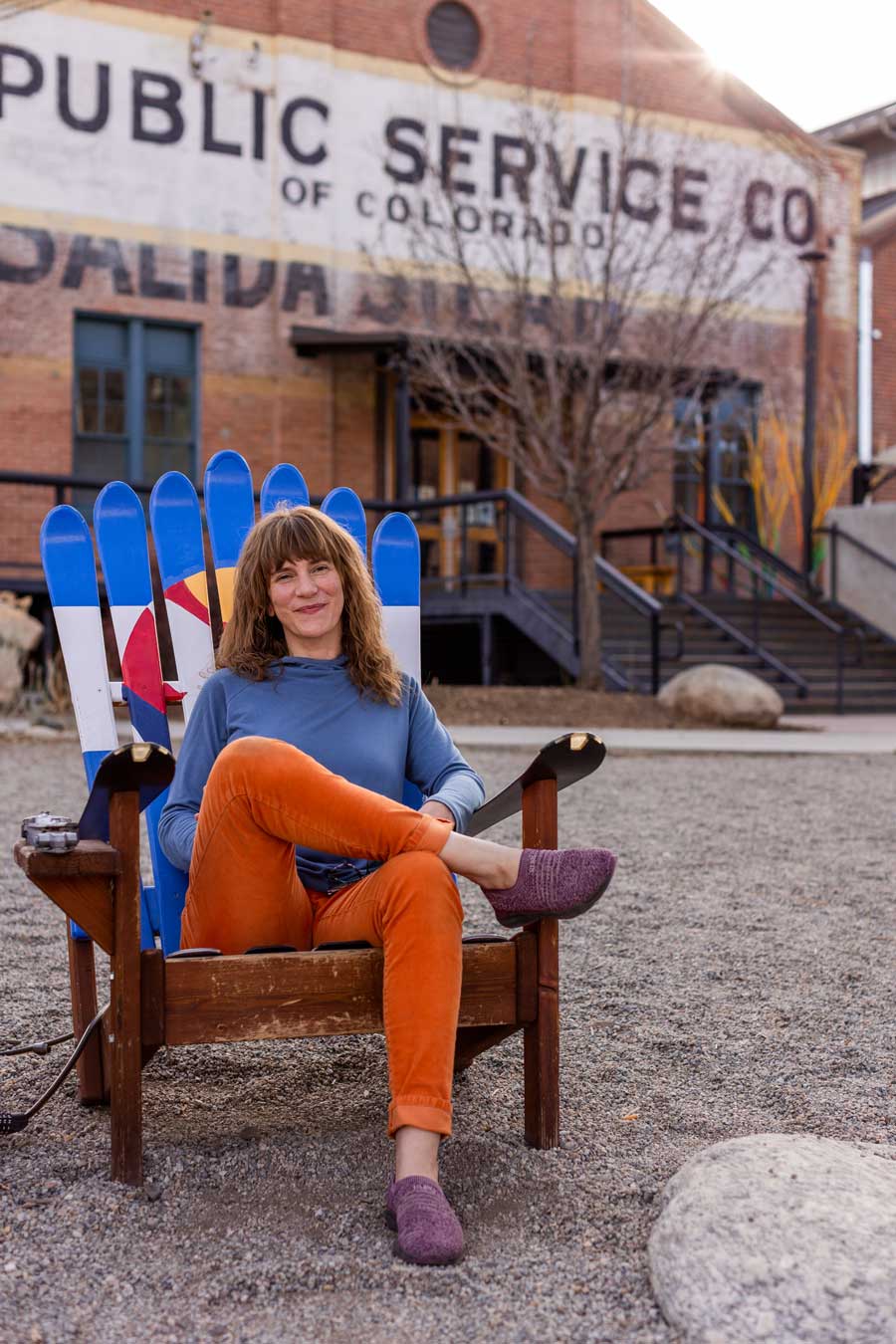Envision Web Designers Salida - Custom Website Designs, Hosting and Organic SEO - Jess sitting on chair outside of Salida Steamplant